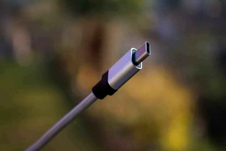 USB-C car adapters in a car center console with phone and tablet charging