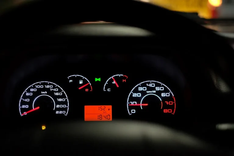Car owner using a BlueDriver OBD2 scanner and phone in a sedan driveway scene