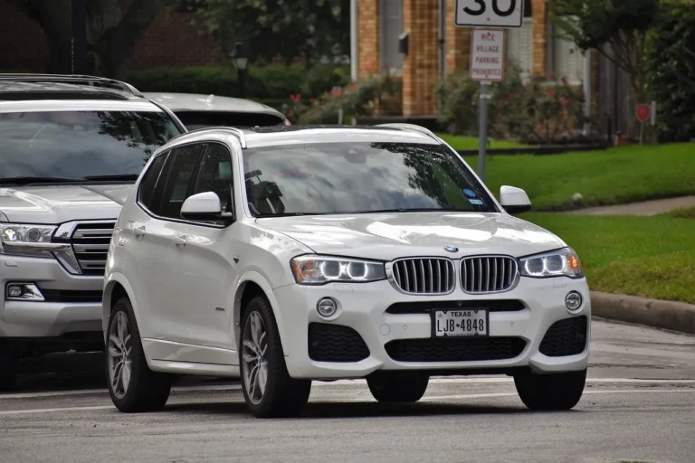 BMW X3 and Acura MDX parked side by side in a suburban driveway