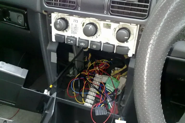 Boss Audio car stereo installed in a sedan dashboard with the cabin lit by natural daylight