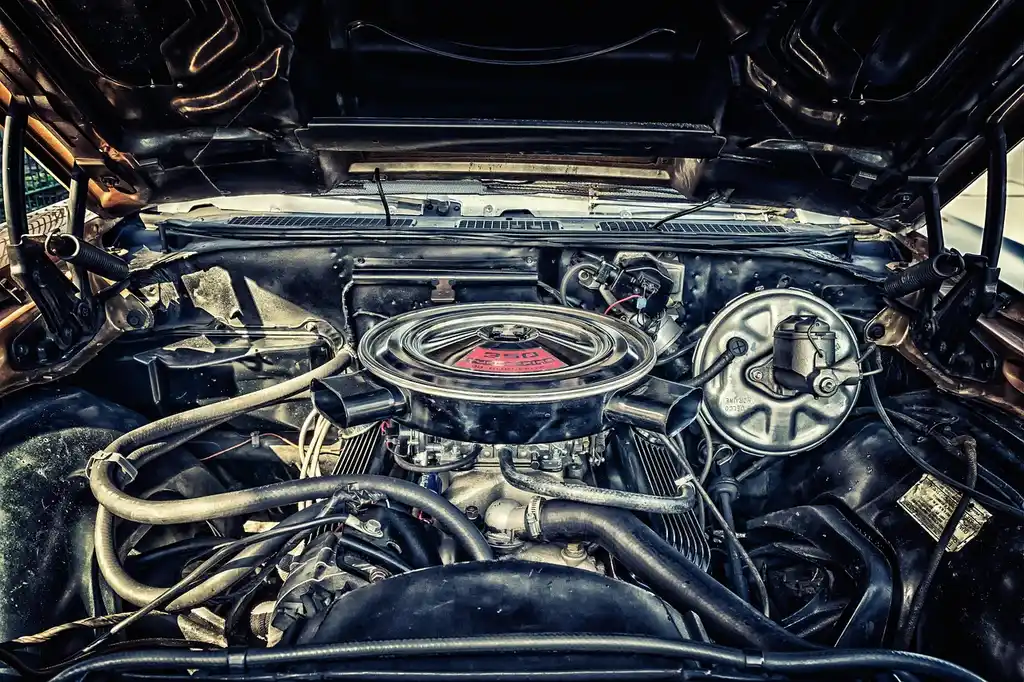 Mechanic and car owner compare a dirty cabin air filter and engine air filter beside an open car.