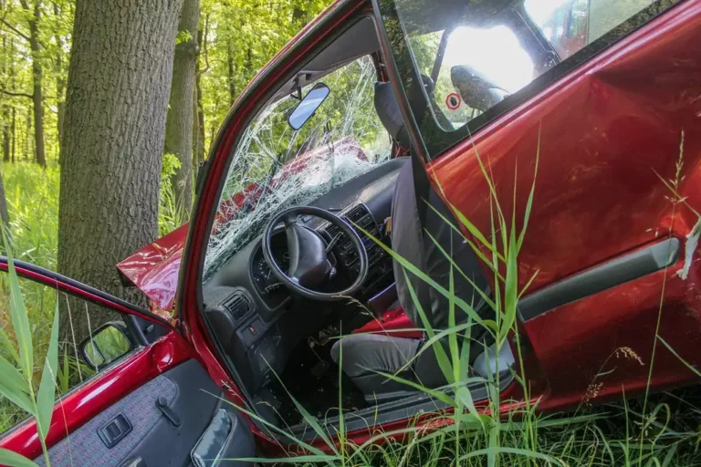 Worried adult reviewing accident bills and paperwork after a car accident at a kitchen table
