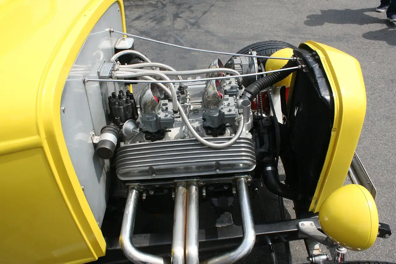 Car owner and mechanic reviewing maintenance for a sedan in a sunlit repair bay