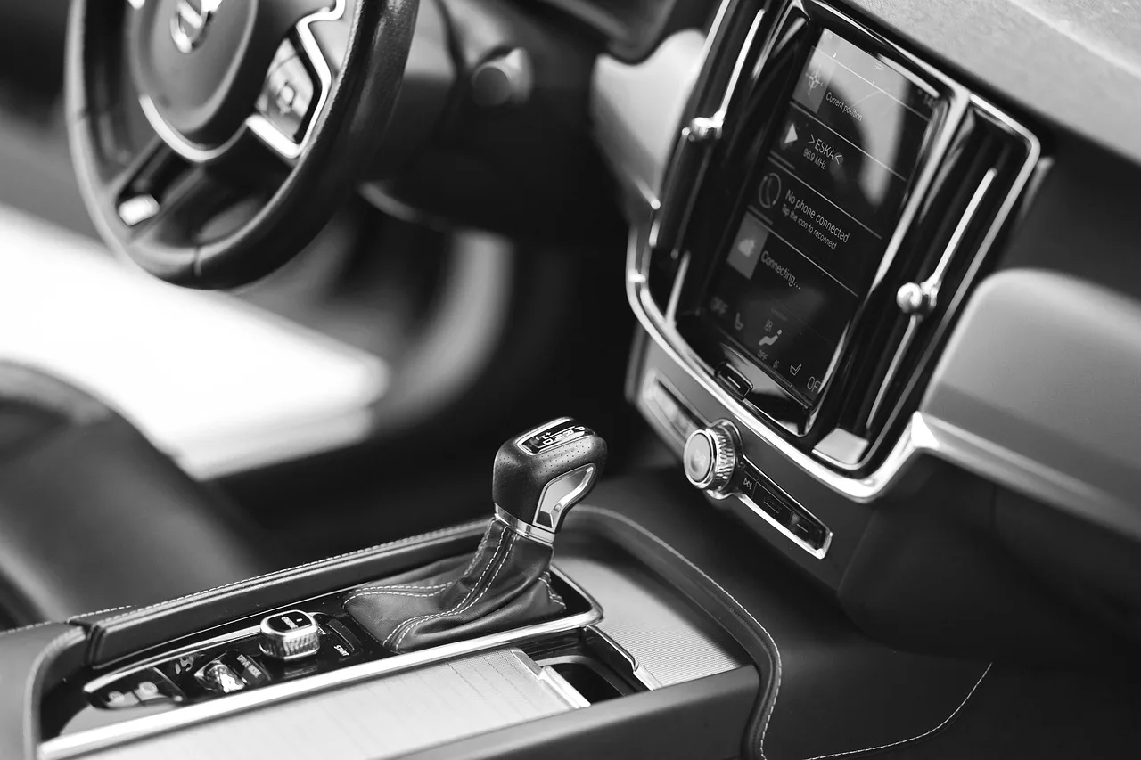 Chemical Guys Total Interior Cleaner being used on a clean car dashboard and center console