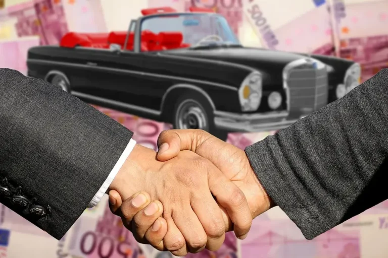 Borrower and co-signer reviewing car loan papers with a dealer in a bright office