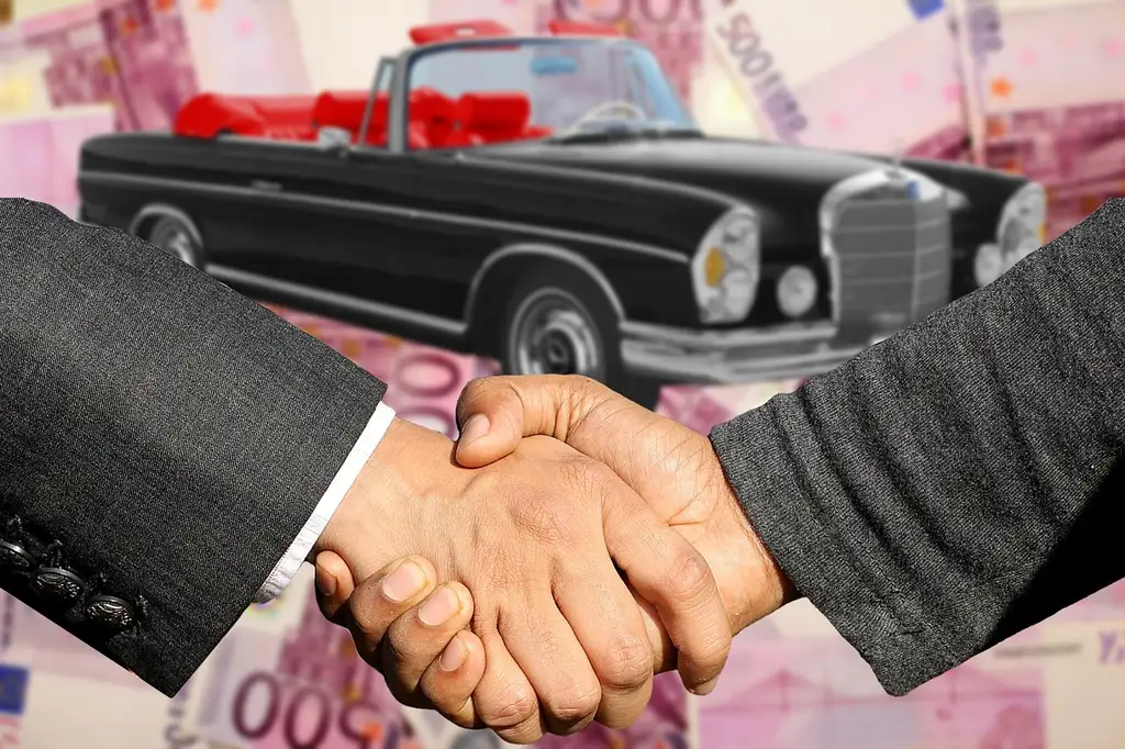 Borrower and co-signer reviewing car loan papers with a dealer in a bright office