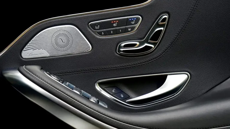 Cooling seat for car on a front car seat with a ventilated cushion and driver in natural sunlight.