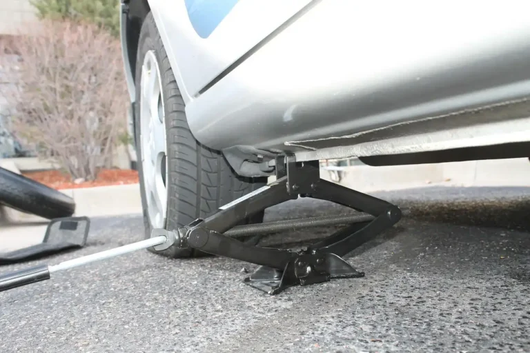 2023 CR-V Hybrid cargo area with the floor lifted as hands check for a spare tire
