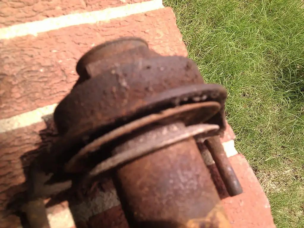Close-up of a worn driveshaft support bearing on a workbench