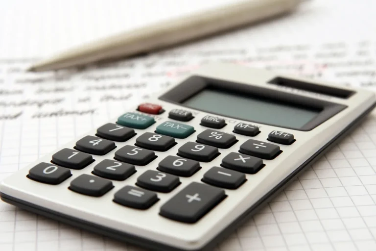 A concerned driver reviews car lease paperwork and a calculator at a kitchen table.