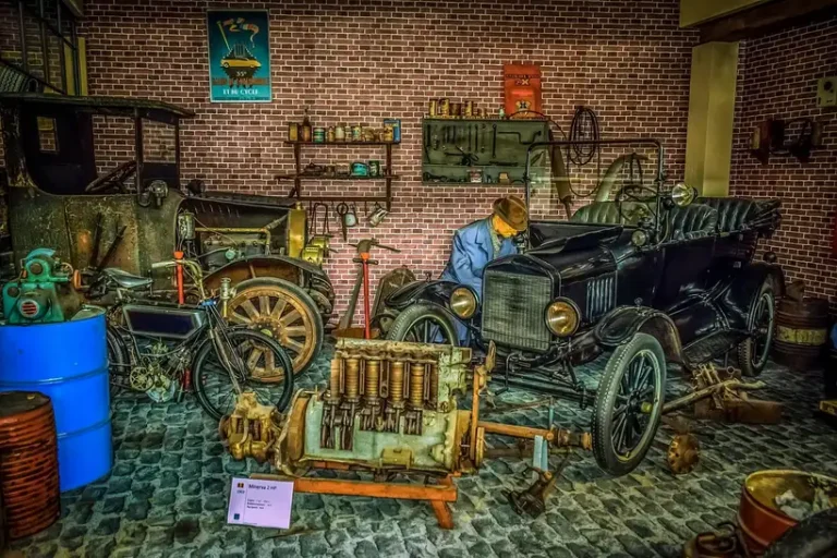 Home mechanic and professional mechanic beside a sedan with hood open, comparing tools and repair estimate.