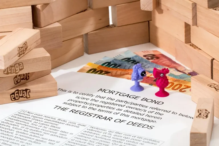 A couple reviews car loan papers with keys and a calculator on the table