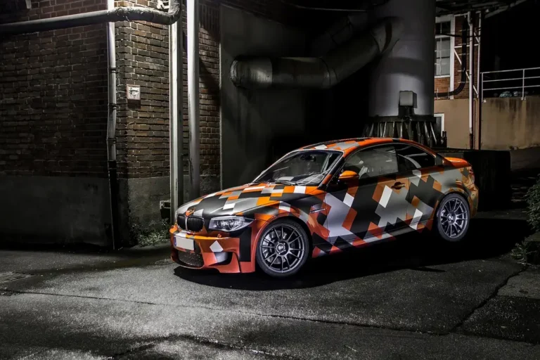 Glow in the dark car wrap on a sports car being inspected at dusk