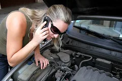 Driver in a rental car reviewing insurance costs beside a phone and paperwork