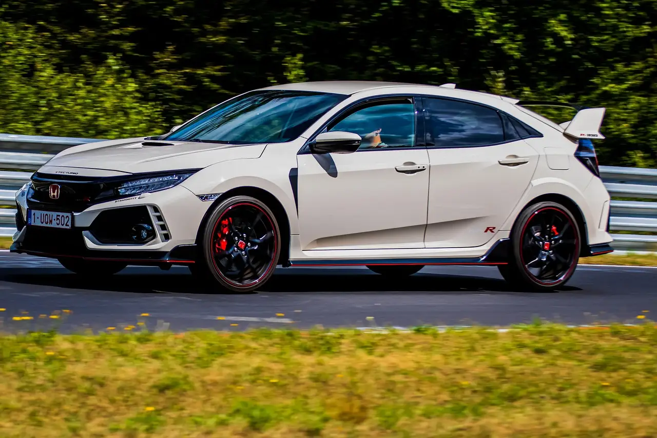 Honda Civic sedan and hatchback parked side by side showing rear cargo area differences