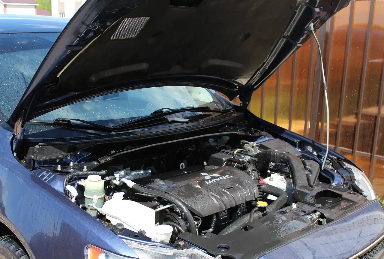 Legacy Honda cars in a garage with the hood open and ECU area visible