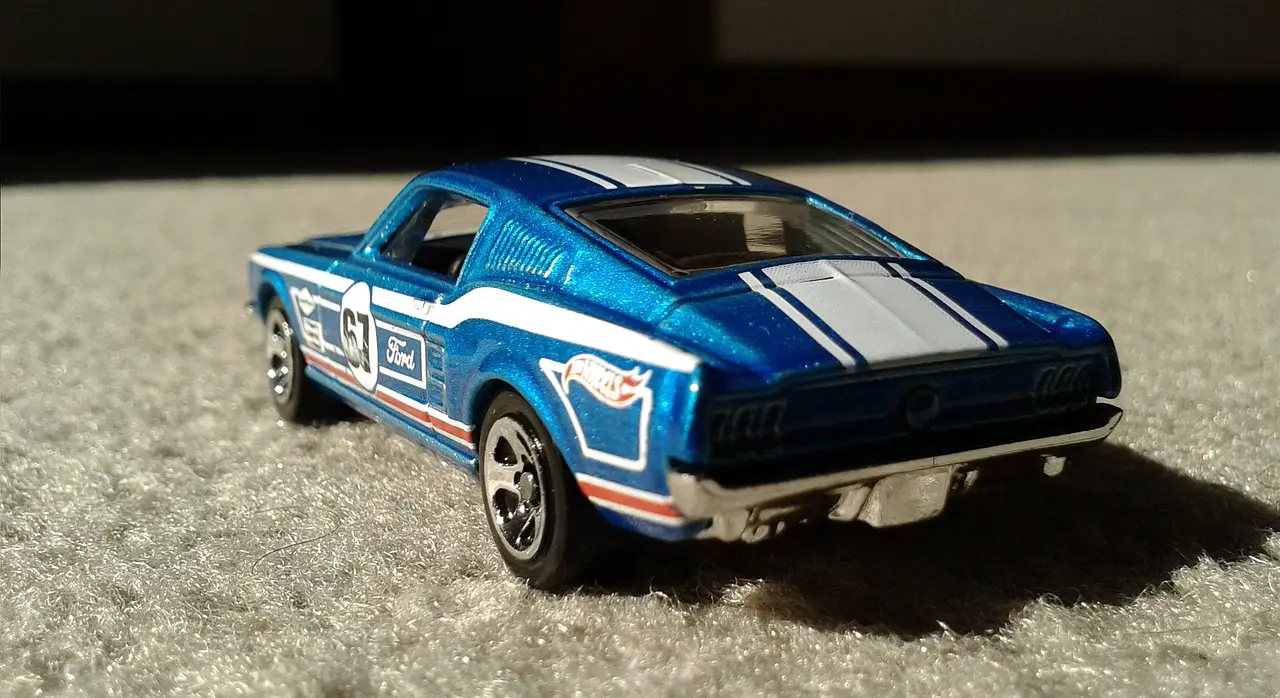 Hot Wheels Car Culture Ford GT die-cast on a collector’s desk with a magnifying glass