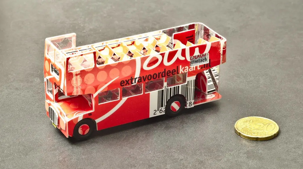 Collector’s hands comparing two Hot Wheels cars side by side on a tabletop
