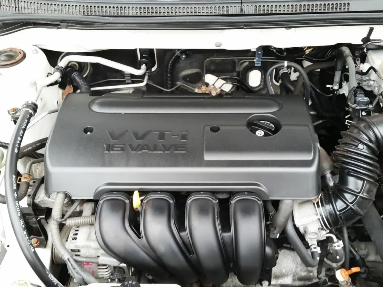 Mechanic and customer reviewing a car service estimate beside an open hood