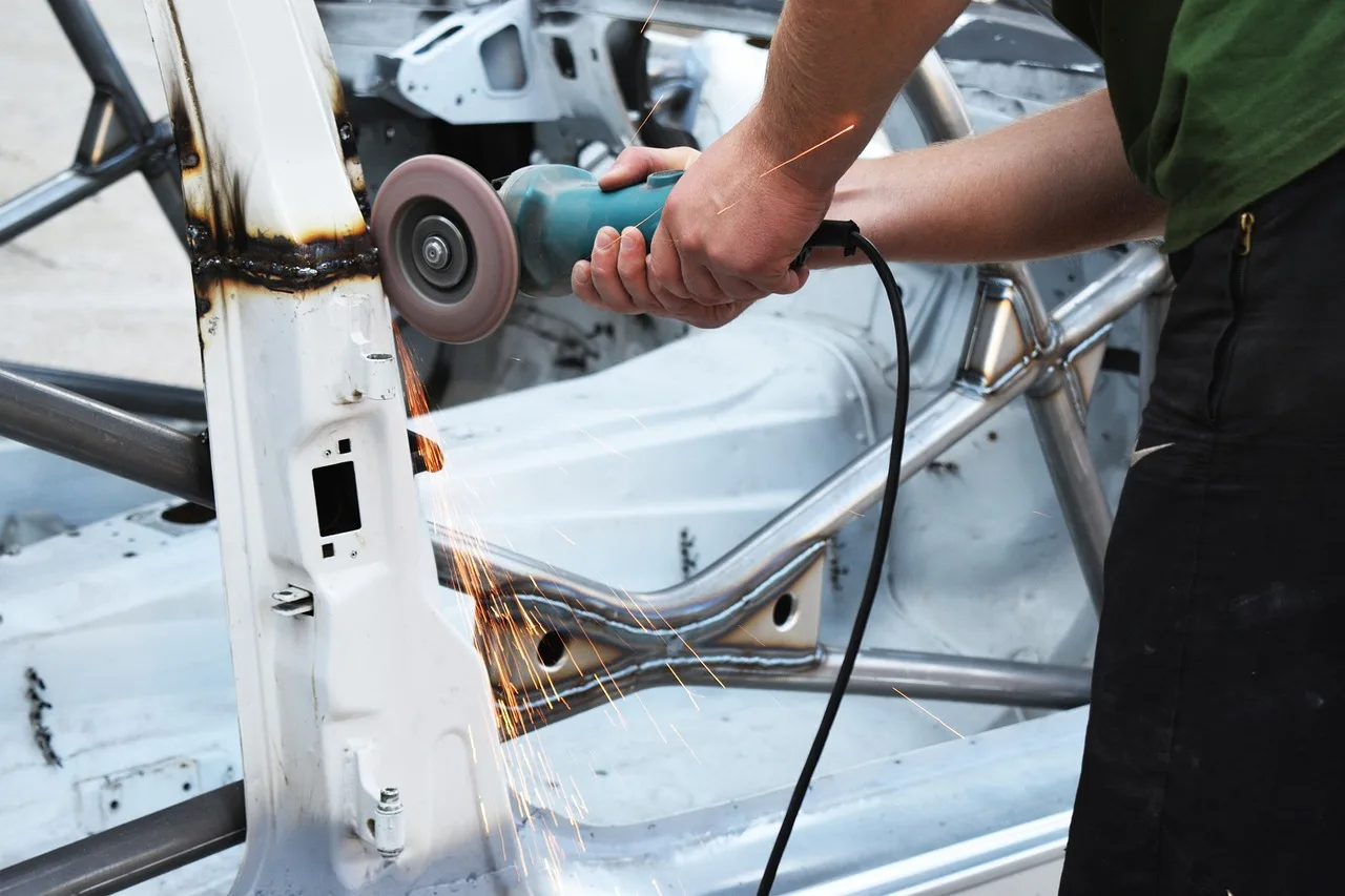 South African family sedan in a workshop with a mechanic and service bay equipment