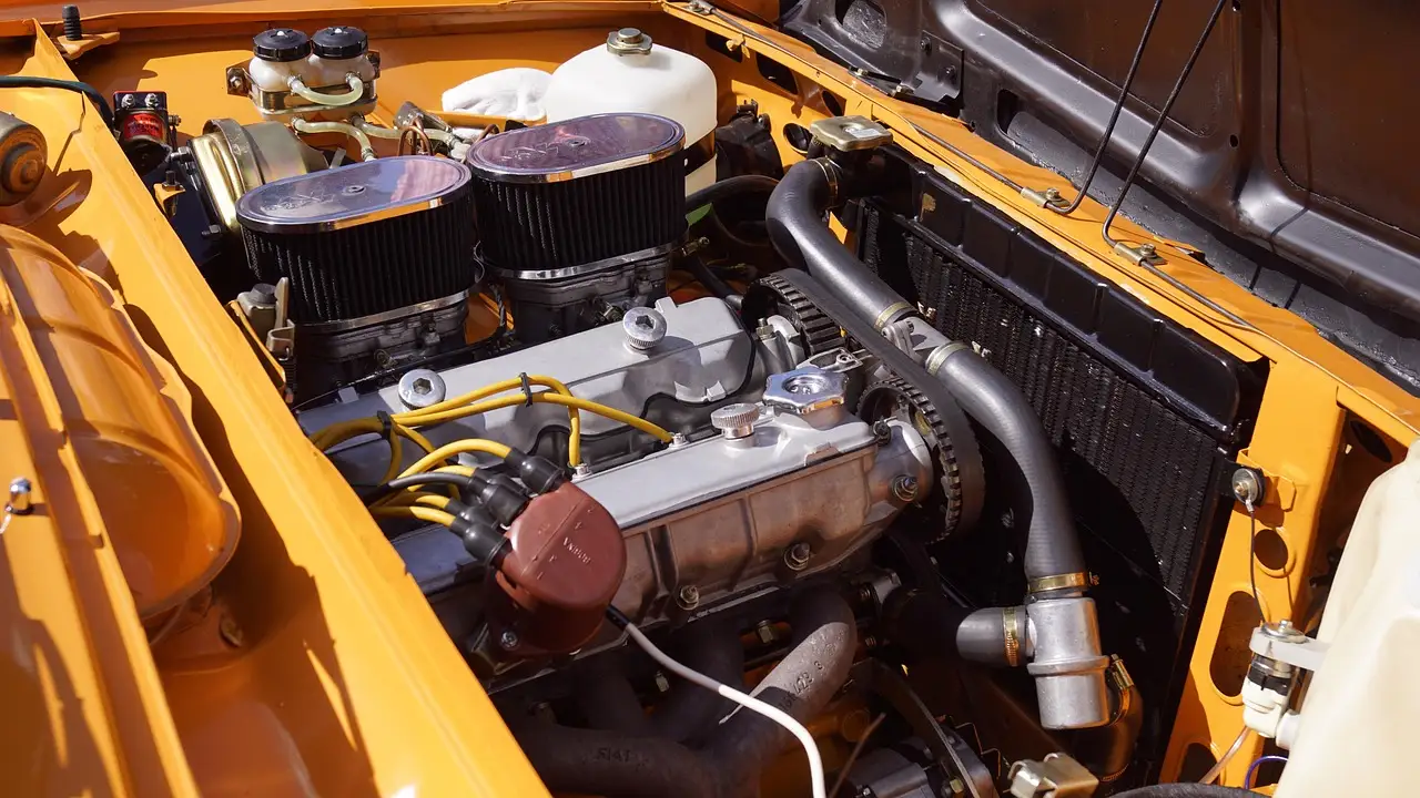 Mechanic inspecting a car engine air filter beside an open hood in a bright repair bay