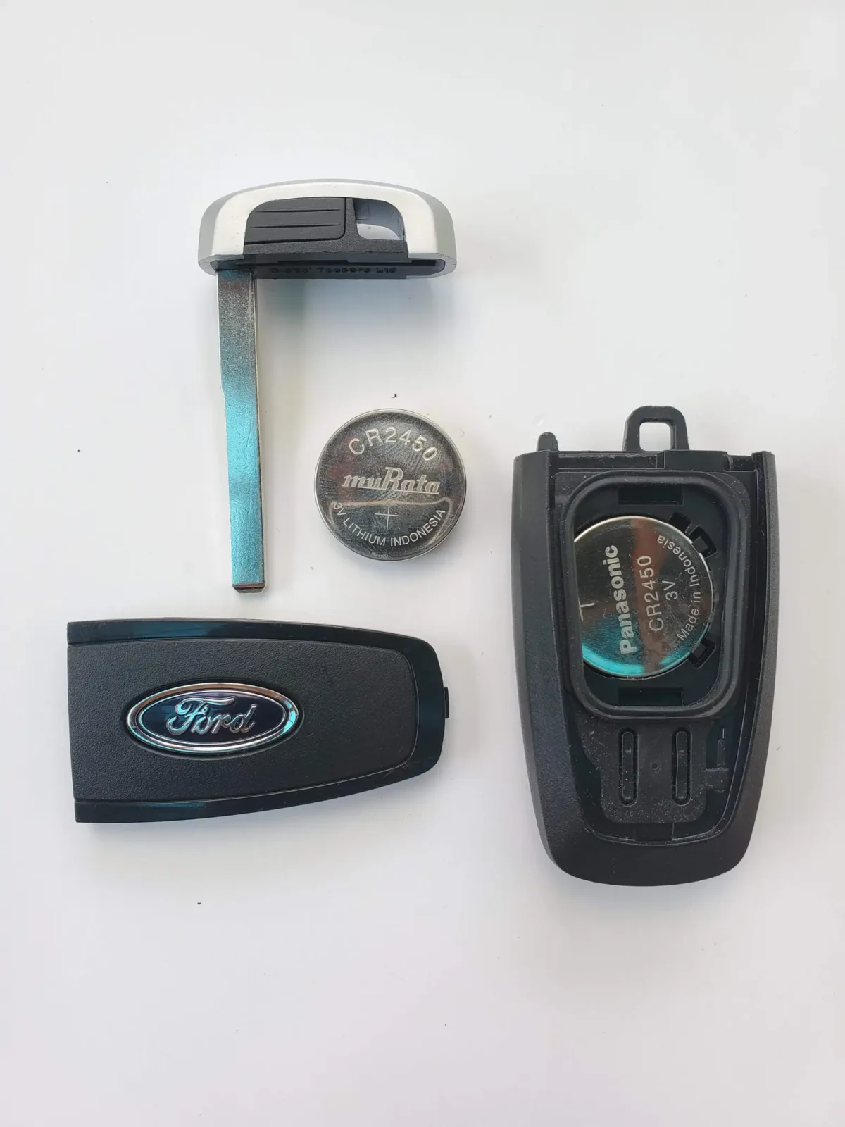 Hand pressing a Ford key fob button next to a vehicle door handle and window.