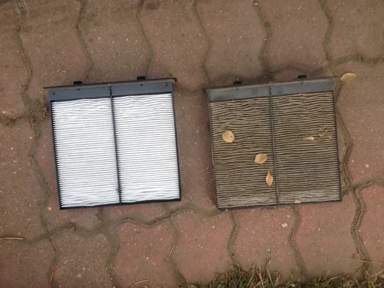 Car owner holds a K&N cabin air filter beside an open glove box in a garage