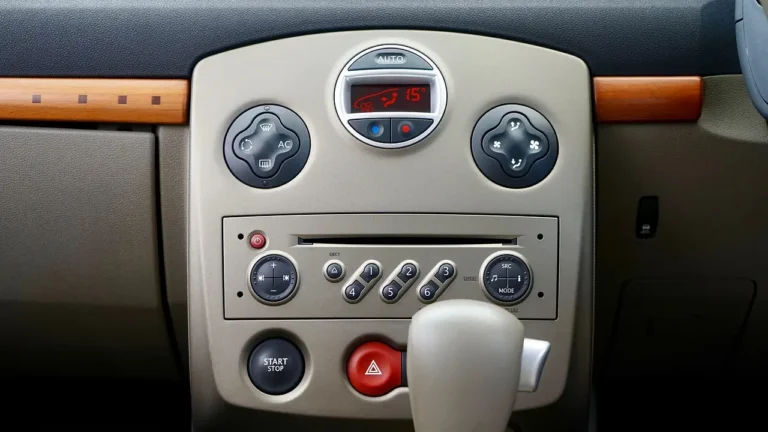 Driver adjusting a vintage car radio in a 1970s sedan with visible speakers and vinyl interior.