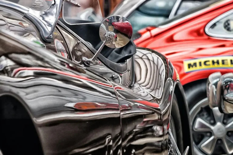 Person comparing plastic trim restorer bottles beside a SUV with faded black exterior trim