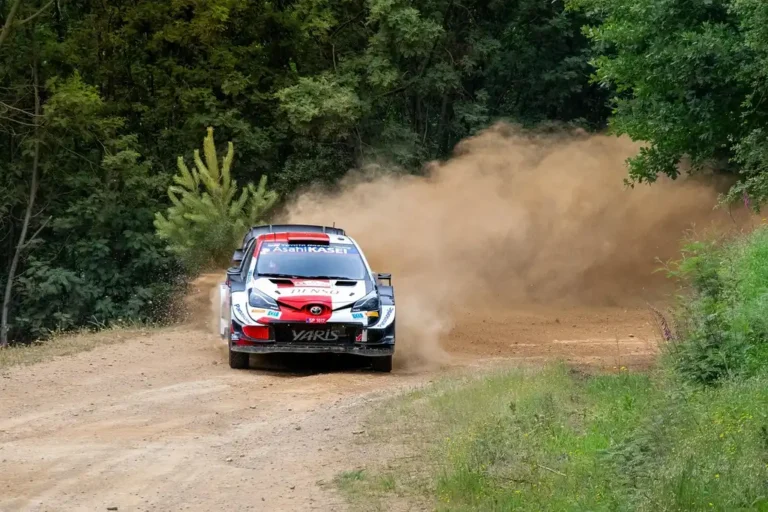 Rally car and drift car parked side by side, showing contrasting suspension and tire setup