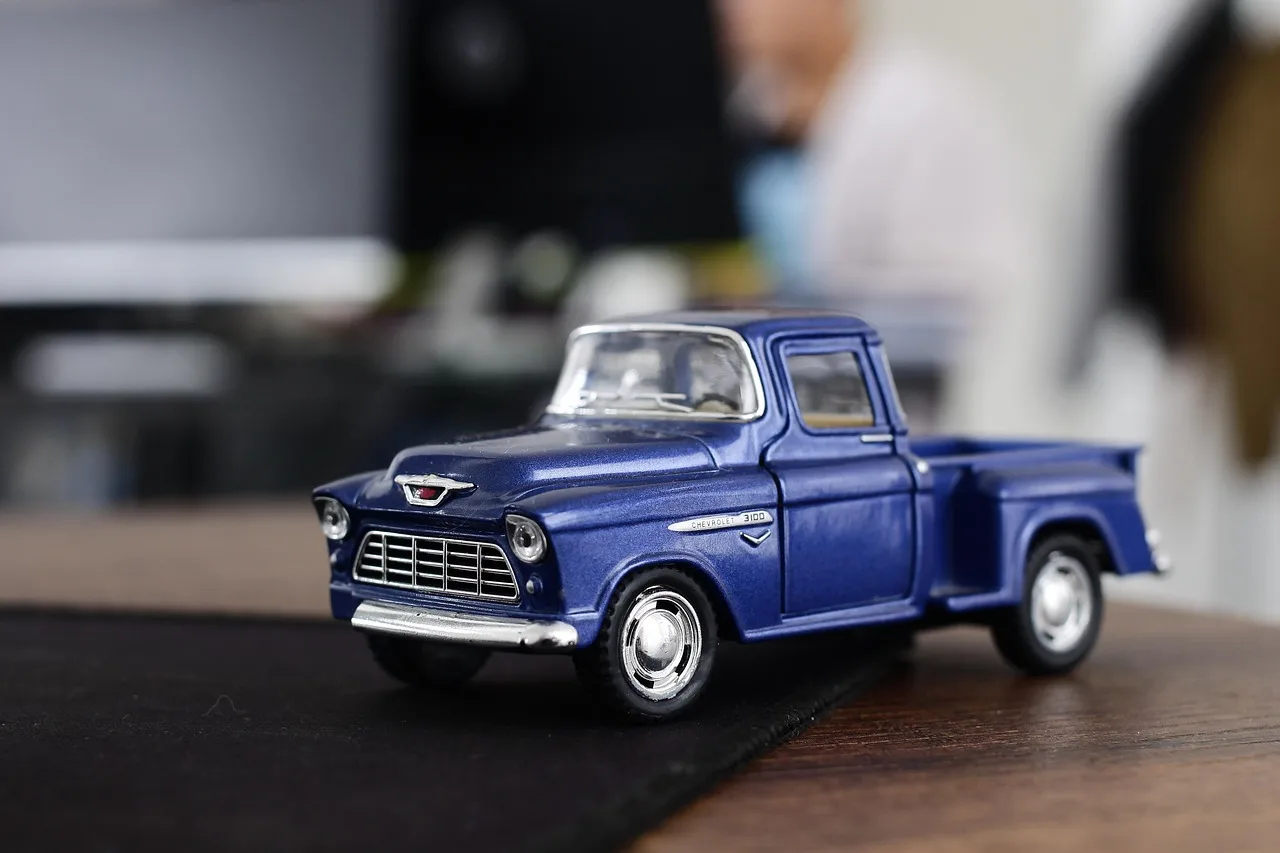 Restored Matchbox cars and an original worn example on a tabletop under natural light.
