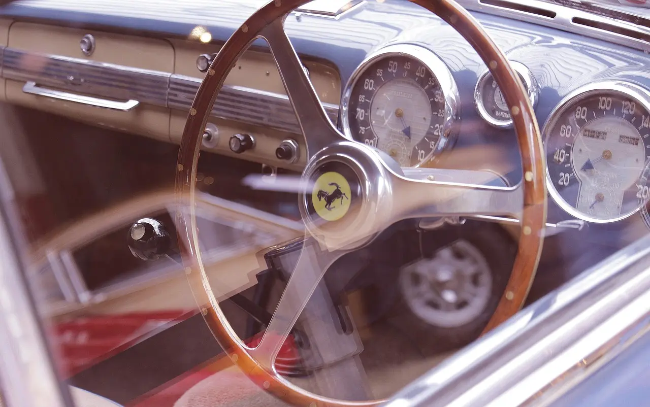 Person fitting a steering wheel cover inside a car, checking grip and fit