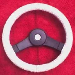 Hands stretching a steering wheel cover onto a car wheel, showing the snug fit