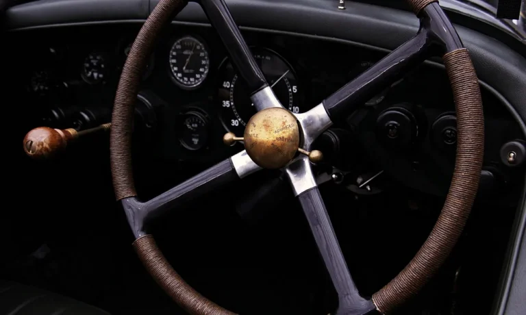 Driver holds a steering wheel cover and a steering wheel wrap beside a car steering wheel.