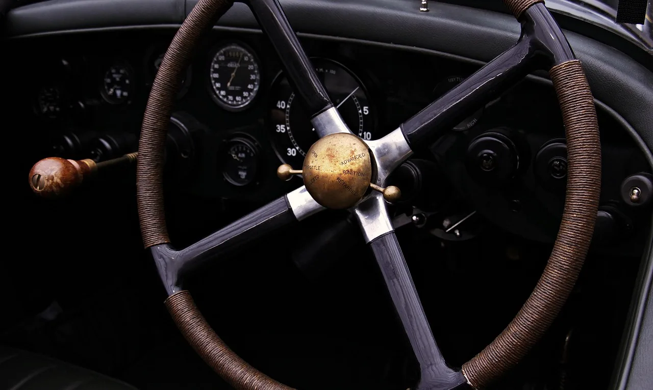Driver holds a steering wheel cover and a steering wheel wrap beside a car steering wheel.