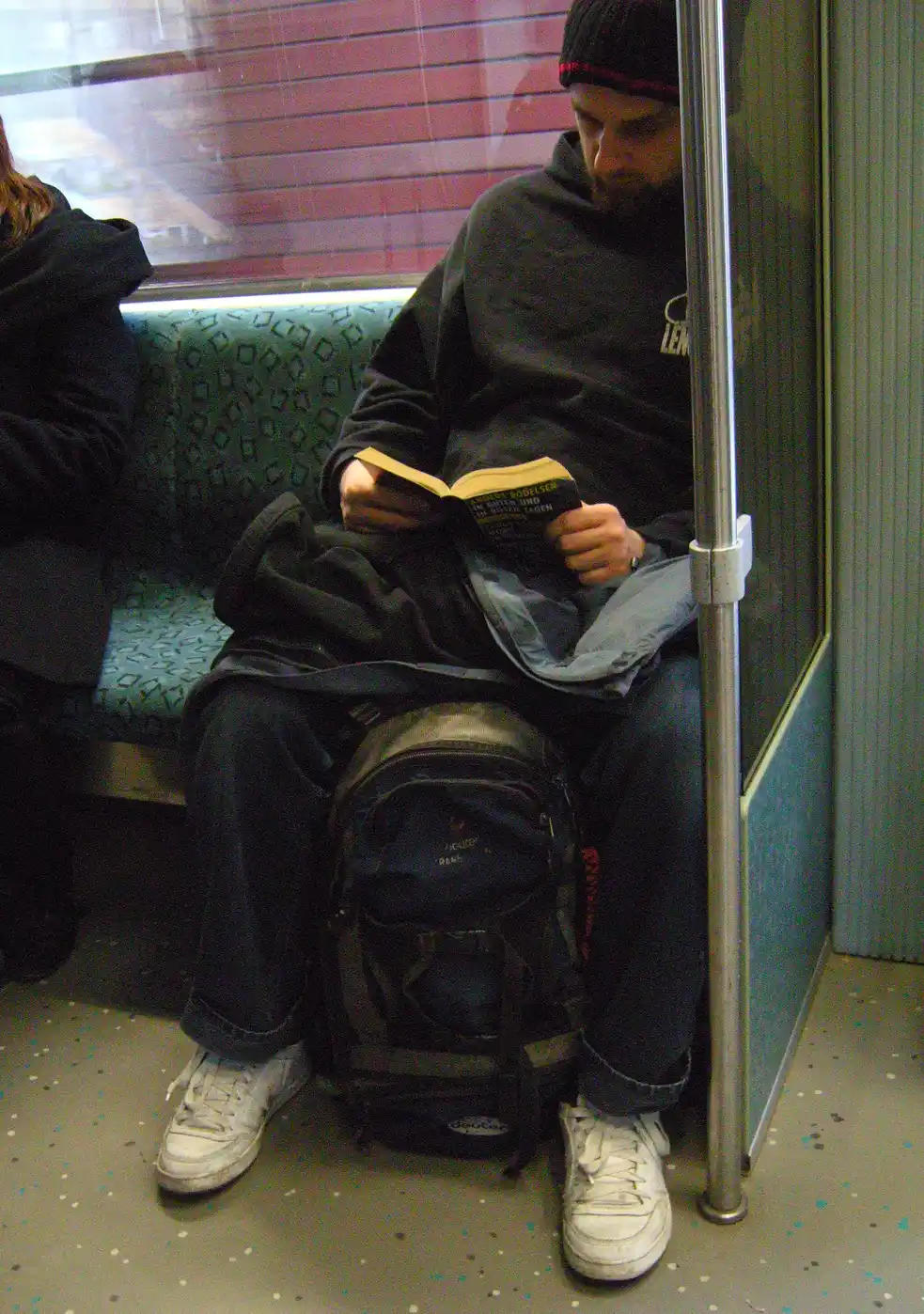 A hand taps a transit card beside a bike lock and grocery list on a phone.