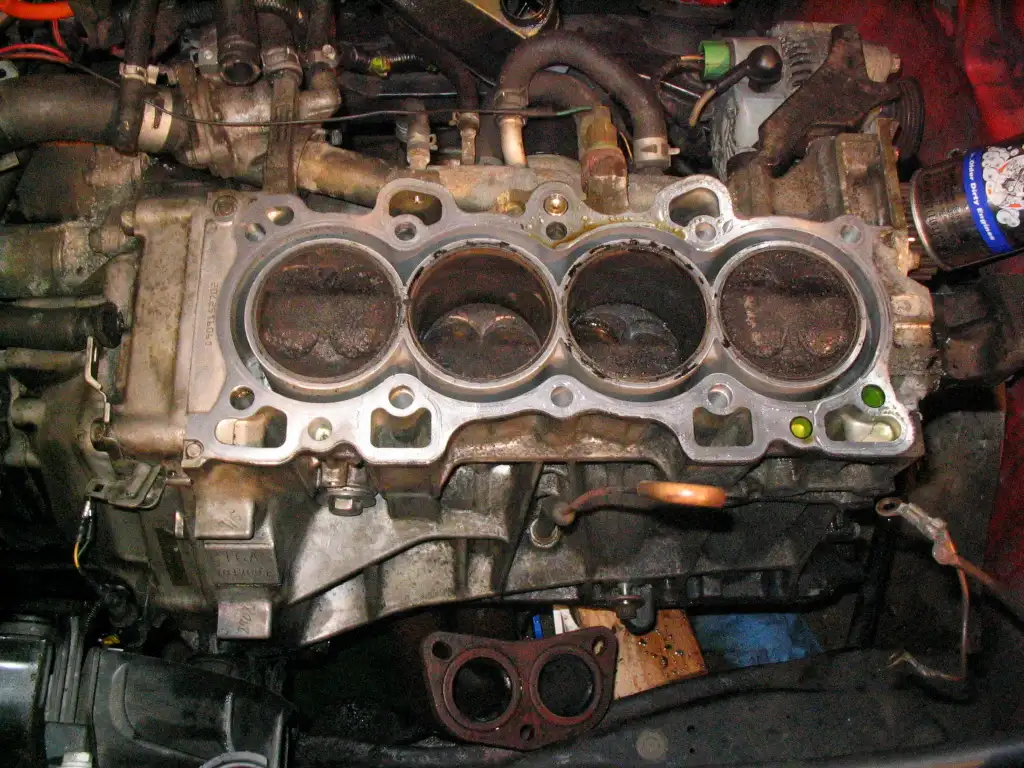 Close-up of a Honda Civic coolant reservoir showing the MIN and MAX level marks