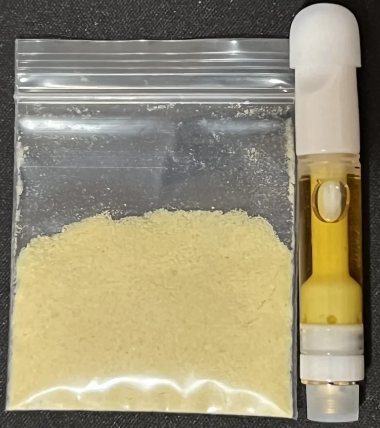 Person priming a Big Chief cartridge on a tidy workbench with e-liquid and vape device