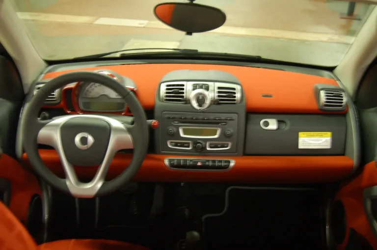 Chevy Equinox interior with a driver reaching for the stability control button on the center console