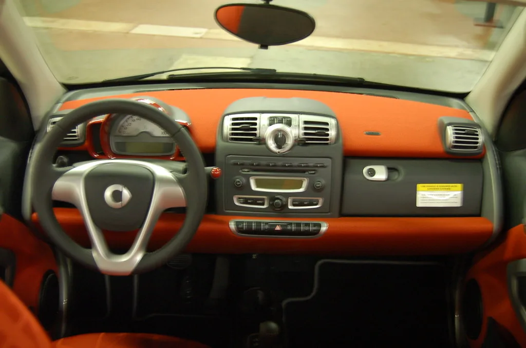 Chevy Equinox interior with a driver reaching for the stability control button on the center console