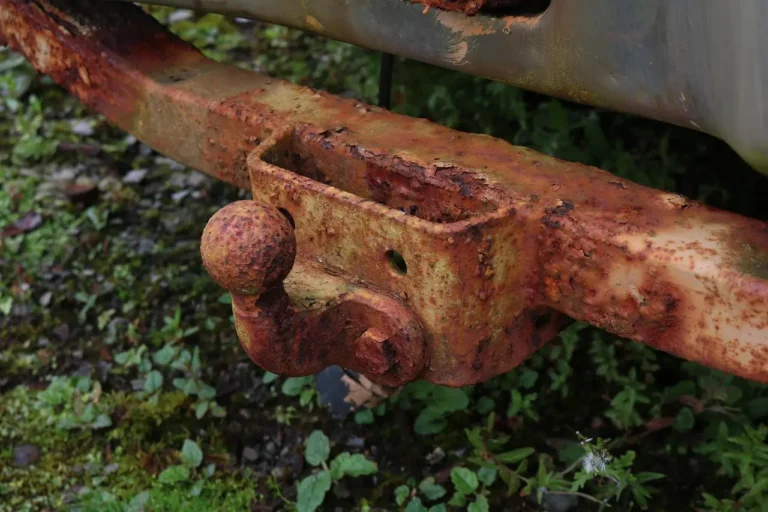 Tow hitch for car scene with SUV, small trailer, and bike rack in natural daylight