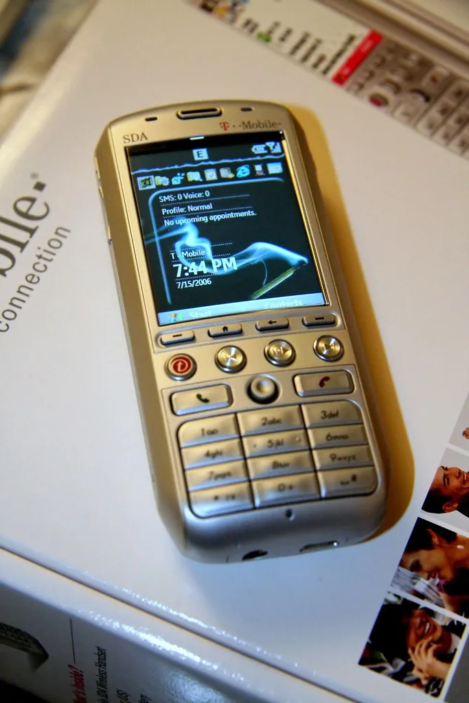 Hands entering a porting PIN on a smartphone beside a SIM card and account details