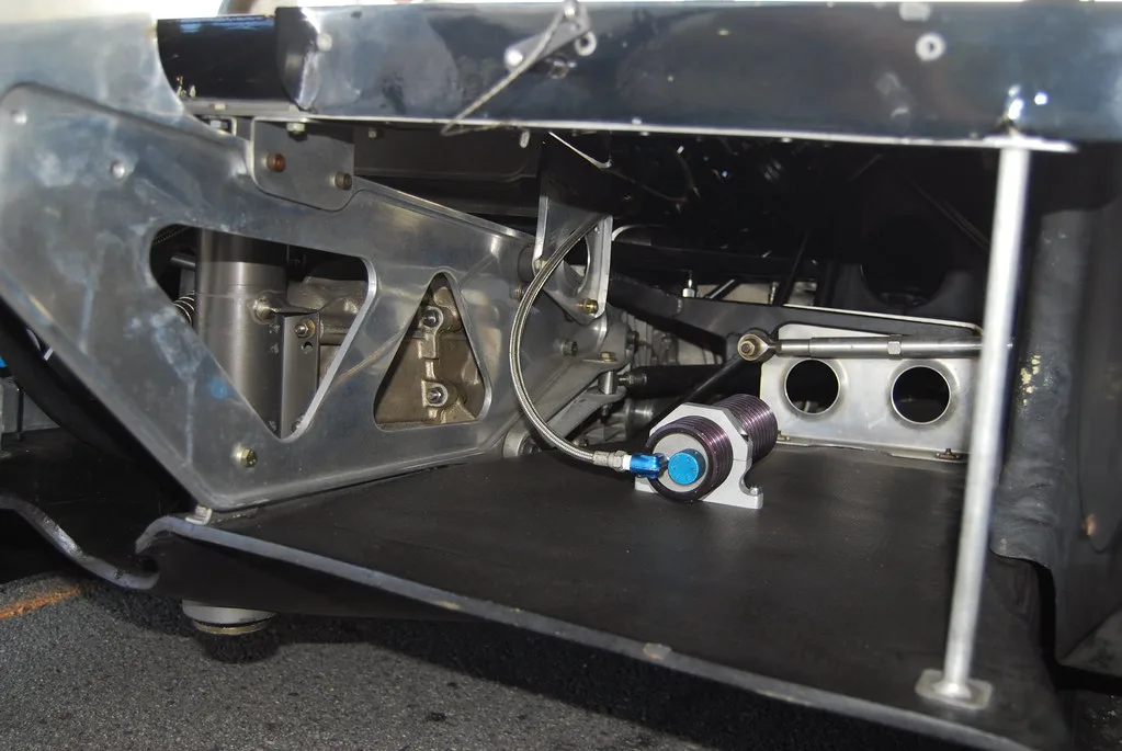 Close-up of a transmission cooler, hoses, clamps, and fan assembly on a workbench