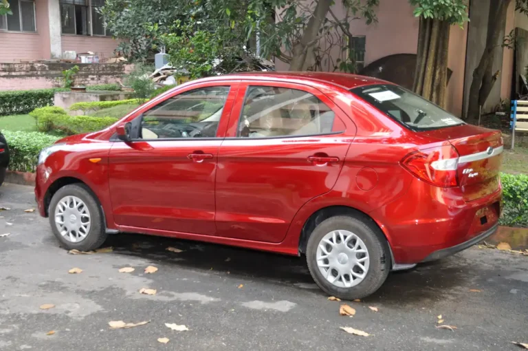 Volkswagen Jetta parked on a suburban street with a person standing beside it in warm natural light