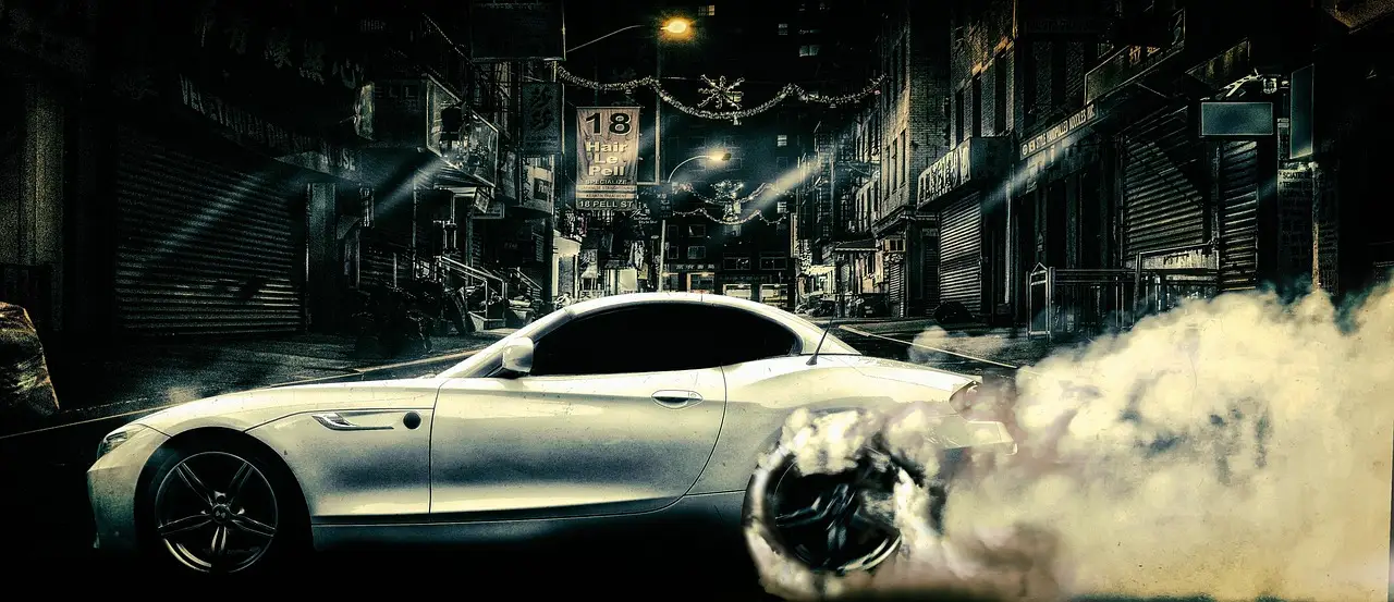 Car sideshow scene on a city street with a spinning car, smoke, and spectators standing back