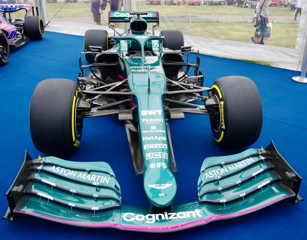 Close-up of a Formula 1 hybrid power unit and rear suspension parts on a workshop stand
