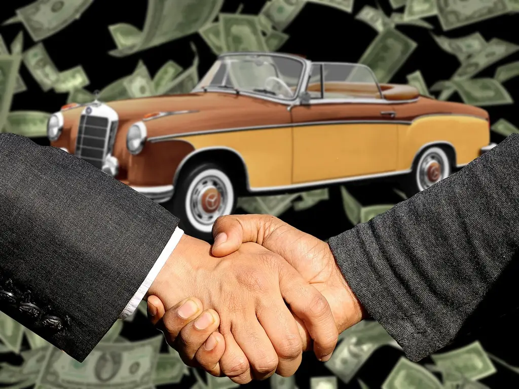 Car buyer and finance manager reviewing an itemized dealership fee worksheet at a desk