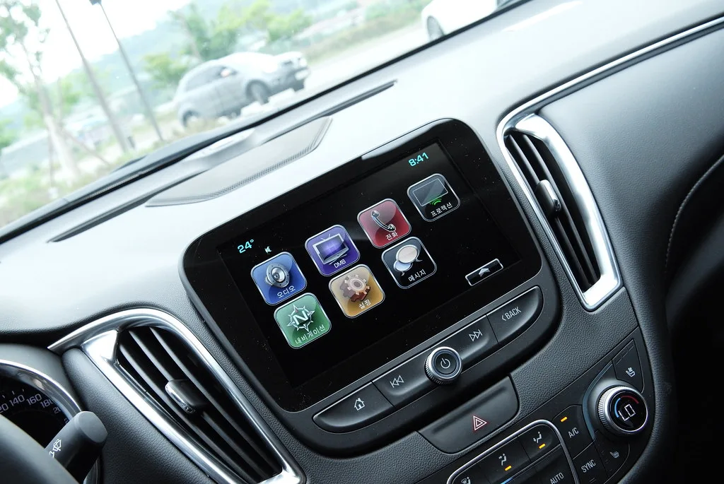 Close-up of a car infotainment unit opened behind the center console trim.