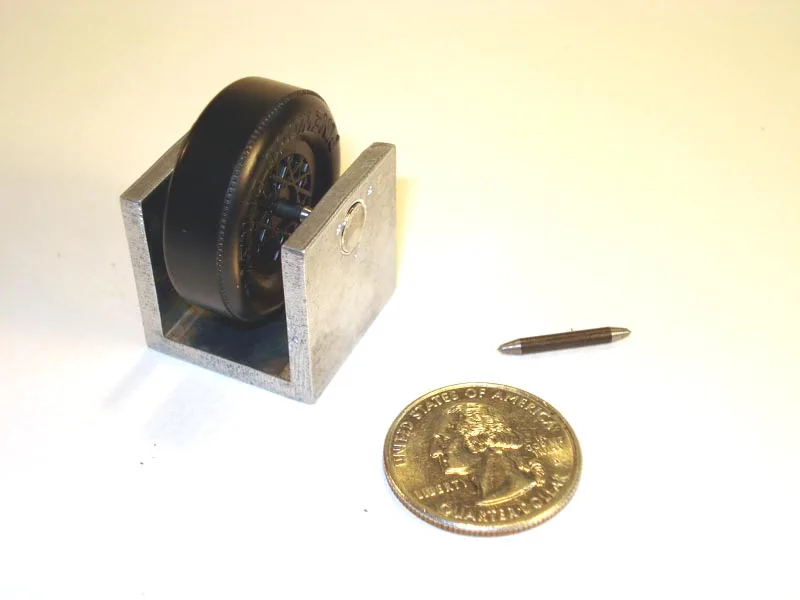 Close-up of a tire mounted on a spin balancer with a technician adjusting it.