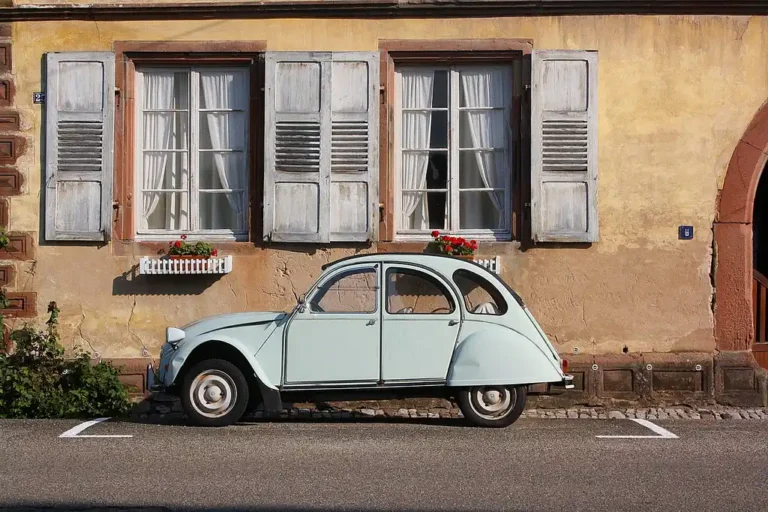 When Did Cars Stop Having Crank Windows? in a sedan interior with manual crank and power window controls
